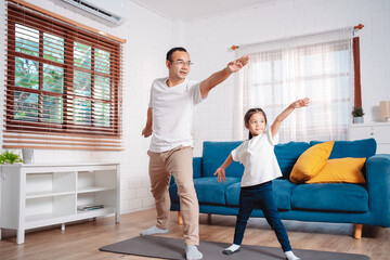 Father and daughter exercising together happily at home. for flexibility build muscle strength, Sport workout training family together concept.