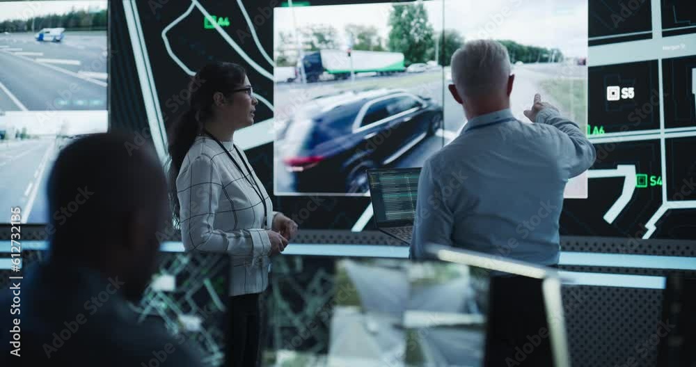 Poster Diverse Team of Specialists Analyze Surveillance Feeds, Monitor Targets on a GPS City Map, Ensure Efficient Traffic Operations. Intensive Work in a Monitoring Room with Big Data Analytics Engineers