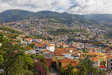 Fototapeta na wymiar The suburbs of Funchal built on the hills around the city