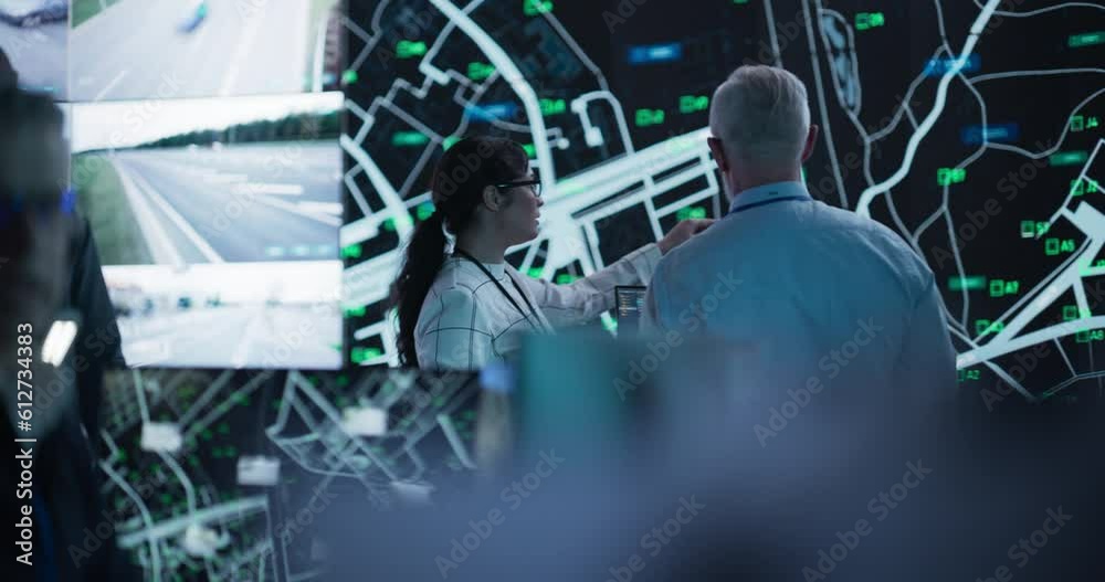 Aufkleber middle aged male officer works on a computer with surveillance software in a traffic monitoring cent