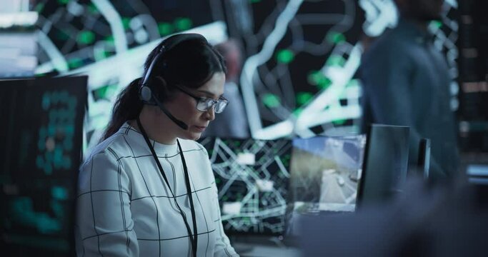 Portrait of a Female Fleet Operator Working in an Office Hub for Order Delivery, Control and Client Support. Logistics Manager Wearing a Headset, Having a Conversation with Team Leader