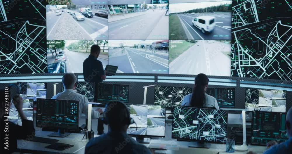 Aufkleber Dark Monitoring Room with Multiethnic Specialists Monitoring Surveillance Feeds and Coordinating Traffic Operations on Desktop Computers. Employees Working in High-Tech Office with Multiple Screens
