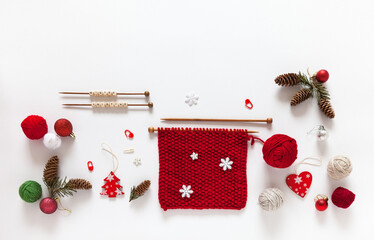 Seasonal needlework. Words Winter knitting on wooden beads. Red knitting, balls of woolen yarn,...