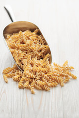 Chickpea bean fusilli pasta on a wooden background.