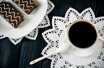 Table setting with cookies with chocolate and coffee drink. Coffee and cakes in chocolate sauce on...