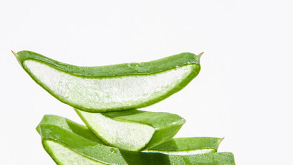 Slides, pieces of green fresh aloe vera. On a white background.