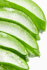Slides, pieces of green fresh aloe vera. On a white background.
