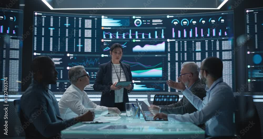 Poster Management Meeting in a Big Data Monitoring Company. Diverse Team of Data Scientists Discussing Graphs and Reports on a Big Digital Screen in the Office. Female Team Leader is Making a Presentation