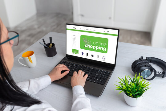 Online shopping laptop with business storefront. Woman use a laptop to search an ecommerce web site