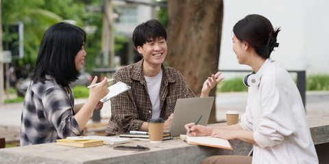 Beautiful young Asian people college student with friends at outdoors. College student working on the college campus.