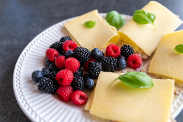 Low carb Crispbread sandwich with old gouda cheese and fresh berries on a plate