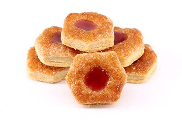 Fototapeta premium Small puff pastry cookies stuffed with berries jam on a white background