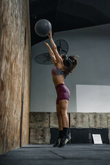 Woman training with a weighted ball