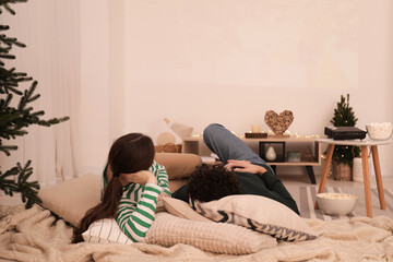 Couple watching movie via video projector at home