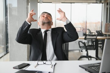 Angry businessman with document shouting at somebody