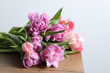Beautiful bouquet of colorful tulip flowers on wooden table