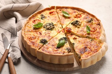 Delicious homemade vegetable quiche and cutlery on table