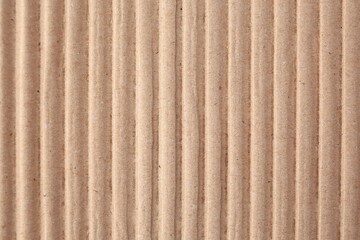 Texture of beige corrugated paper sheet as background, closeup