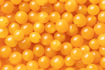 Yellow Tomberry tomatoes close up full frame as background