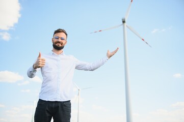 Engineer working at alternative renewable wind energy farm - Sustainable energy industry concept