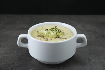Bowl of delicious celery soup on gray table