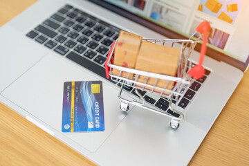 Boxes with credit card on a laptop computer. online shopping, Marketplace platform website,...