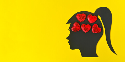 girl dreaming of love. Banner concept on a yellow background silhouette of a woman's head with...