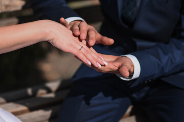bride's hand in groom's hand. outdoors