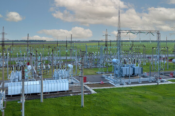 Substation with transformers, insulators and switches distributing high voltage.
