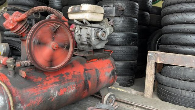Old air compressor used for inflating car or motorcycle tire.