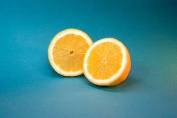 Halves of an orange on a blue background. Contrast composition