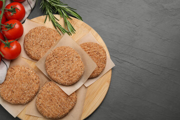 Raw vegan cutlets with breadcrumbs on black table, flat lay. Space for text