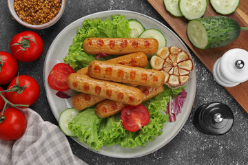 Delicious grilled vegan sausages with fresh herbs and vegetables on grey table, flat lay