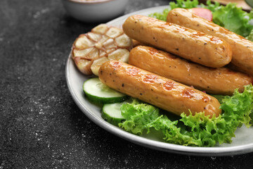 Delicious grilled vegan sausages on grey table, closeup. Space for text