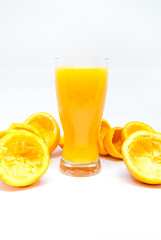 glass of orange juice and oranges