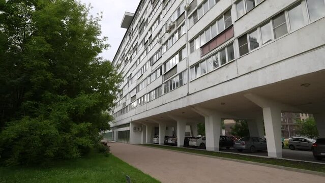 The facade of an unusual long apartment building with unusual balconies. Dolly camera7. A long house with a strange design