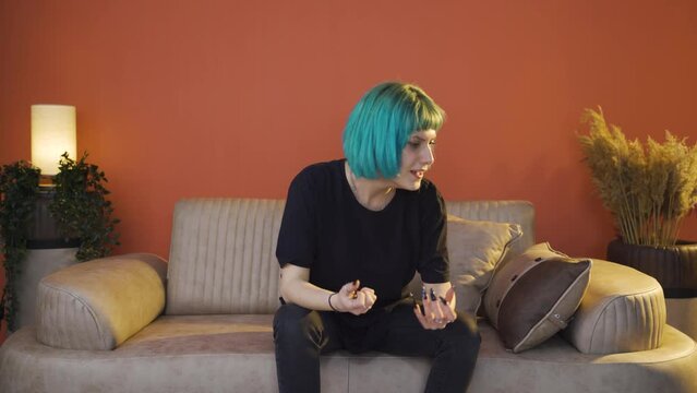 Young woman slapping herself with a nervous breakdown.