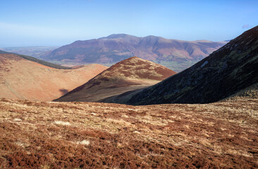 The summit of Outerside in the middle below Causey Pike with Skiddaw in the distance in winter in the English Lake District, UK.