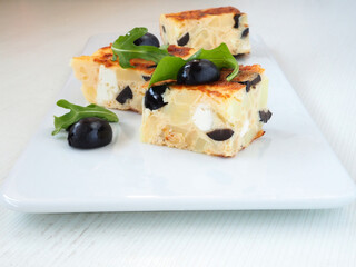 Spanish Potato Omelet with Olives and Feta on Plate