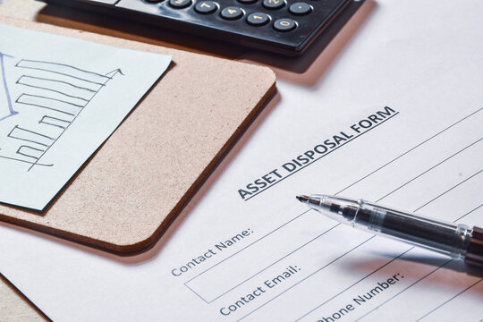 Asset Disposal form on desk. Selective focus.