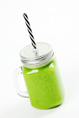 Healthy green smoothie  in a jar mug  on white background