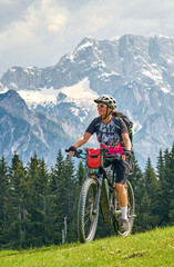 active senior woman on a mountain bike tour in the Julian Alps above Kranska Gora in Slovenia