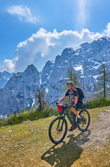 Fototapeta premium active senior woman on a mountain bike tour in the Julian Alps above Kranska Gora in Slovenia