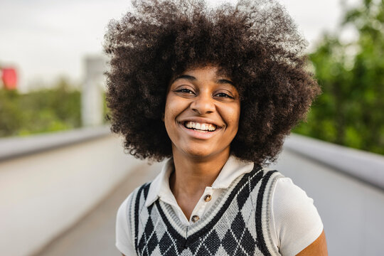 portrait of pretty african american woman smiling outdoors