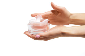 woman's hand is taking cream from a jar with her finger