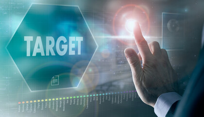 A businessman controlling a futuristic display with a Target business concept on it.
