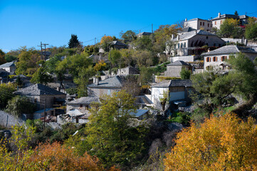 Obraz premium Autumnal landscape showing the stone houses of traditional architecture in the village of Elaphotopos in Zagori of Epirus, Greece