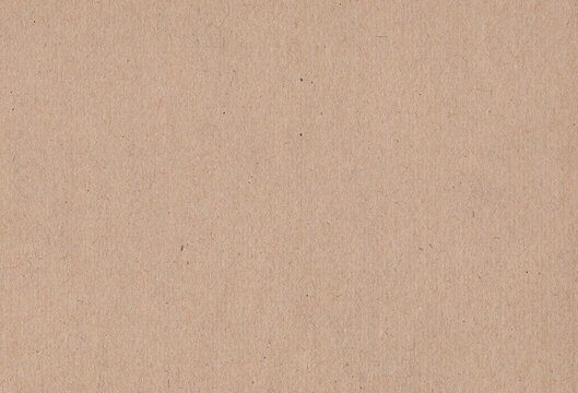 Textured light brown coloured natural cardboard material background. Extra large highly detailed image of empty carton paper image.