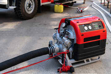 Fire truck equipment. Portable electric pump with valves and hose for supplying water to the fire.