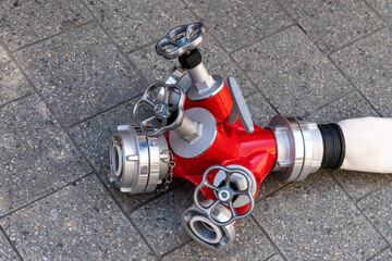 Fire hose water splitter with valves and connecting flanges. Close-up.